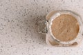 Active sourdough rye sourdough in a rustic jar. Vertical orientation, top view