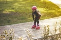 Active sport. A cute girl is rollerblading in the city park