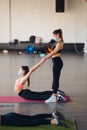 Active sportive woman stretching, young woman helping her