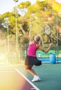 Active sports woman making serve while playing tennis. Racket sport training