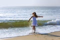 beautiful girl runs along the beach in a summer vacation Royalty Free Stock Photo