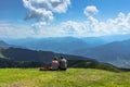 Active sporty couple having rest on the peak of Alps, Austria,Europe.Successful backpackers enjoying view of mountain panorama. Royalty Free Stock Photo