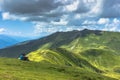 Active sporty couple having rest on the peak of Alps, Austria,Europe.Successful backpackers enjoying view of mountain panorama. Royalty Free Stock Photo