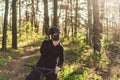 Active sporty woman riding mountain bike on forest trail, wearing a face mask against air pollution and coronavirus. Royalty Free Stock Photo