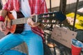 Active street musician changing music with guitar Royalty Free Stock Photo