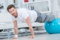 Active strong man having hard training at home