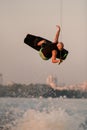 active strong man jumping and flips on wakeboard over splashing wave Royalty Free Stock Photo