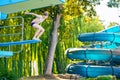 Active teenager boy jumping into an outdoor pool from spring board or 5 meters diving tower learning to dive during Royalty Free Stock Photo