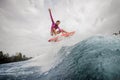 Active teenager girl in the pink swimsuit jumping on the orange Royalty Free Stock Photo