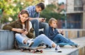 Active teens playing on smarthphones and listening to music