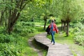 Active thrity year old woman walking a wooden trail through the Brussels wetlands