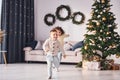 Active time spending. Little brother and sister is at christmas decorated room together Royalty Free Stock Photo