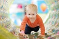 Active toddler boy having fun on inflatable attraction in entertaining center. Funny child is playing on indoor playground. Kids Royalty Free Stock Photo