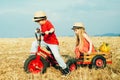 Active toddler kid playing and cycling outdoors. Two Kids having fun in field against blue sky background. Earth day Royalty Free Stock Photo