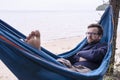 Active tourist is serious dreams and thoughtful while he is resting in a hammock