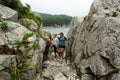 Active tourists mother and daughter walking at hilly terrain with rocky mountain exploring adventure