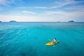 active travel, tourist on kayak paddling on paradise beach in Thailand