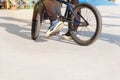 Active urban life. Extreme bike having fun practicing at skatepark ramp in sunny day in city. Urban subculture.