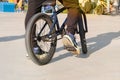 Active urban life. Urban subculture. Extreme bike having fun practicing at skatepark ramp in sunny day in city Royalty Free Stock Photo