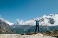 Active vacations concept image. Young hiker backpacker man rising arms with trekking poles enjoying the Thamserku 6608m mountain Royalty Free Stock Photo