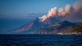 Active volcanic mountain with smoke by the ocean Royalty Free Stock Photo