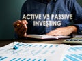 Active vs passive investing concept. The investor is sitting at table. Royalty Free Stock Photo