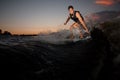 Active wakesurfer jumping on board riding down the river waves a Royalty Free Stock Photo