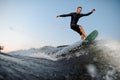 Active wakesurfer jumping on a wake board down the river Royalty Free Stock Photo