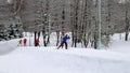 People of different ages, women and men, ski on the ski track in winter on their day off
