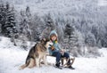 Active winter outdoors games for kids with dog husky. Happy Christmas vacation concept. Boy enjoying winter, playing Royalty Free Stock Photo