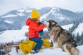 Active winter outdoors games for kids. Happy Christmas vacation concept. Boy enjoying winter with siberian husky dog Royalty Free Stock Photo