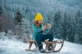 Active winter outdoors games for kids. Happy Christmas vacation concept. Boy enjoying winter, playing with sleigh ride Royalty Free Stock Photo