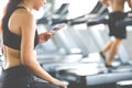 Active woman athlete taking rest and use smartphone after exercising at gym. Fitness Healthy lifestye and workout at gym concept Royalty Free Stock Photo