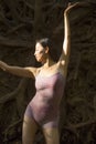 Active woman dancing with overturned tree roots in Manchester, Connecticut Royalty Free Stock Photo