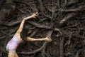 Active woman dancing with overturned tree roots in Manchester, Connecticut Royalty Free Stock Photo