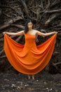 Active woman dancing with overturned tree roots in Manchester, Connecticut Royalty Free Stock Photo