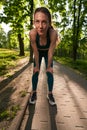 Active woman having break while jogging in nature Royalty Free Stock Photo