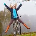 Active woman having fun riding bike in autumn park Royalty Free Stock Photo