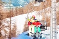 Active woman and her kid son lifting on chairlift Royalty Free Stock Photo
