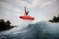 Active woman jumping up the blue slashing wave against the grey Royalty Free Stock Photo