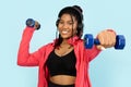 Woman Exercising with Dumbbells and Headphones