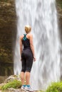 Active woman looking at Pericnik waterfall in Vrata Valley in Triglav National Park in Julian Alps, Slovenia.