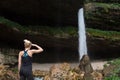 Active woman looking at Pericnik waterfall in Vrata Valley in Triglav National Park in Julian Alps, Slovenia.