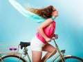 Active woman riding bike bicycle. Hair windblown.