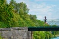 Active woman runner jogging across river bridge, outdoors running Royalty Free Stock Photo