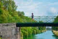 Active woman runner jogging across river bridge, outdoors running Royalty Free Stock Photo