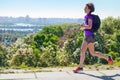 Active woman runner run commutes to work with backpack, city morning run commuting and healthy lifestyle concept, skyline of Kyiv Royalty Free Stock Photo