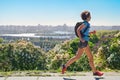 Active woman runner run commutes to work with backpack, city morning run commuting and healthy lifestyle concept, skyline of Kyiv Royalty Free Stock Photo