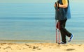 Active woman senior nordic walking on a beach. legs Royalty Free Stock Photo