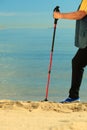 Active woman senior nordic walking on a beach. legs Royalty Free Stock Photo